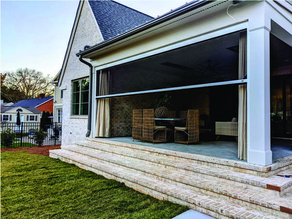 Back porch with motorized screens and brick steps