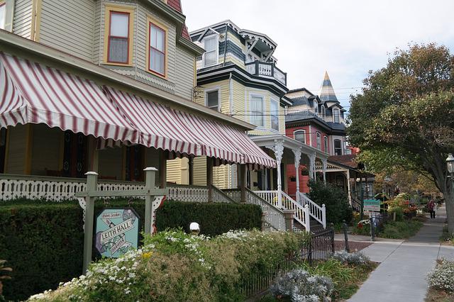 Sidewalk view of townhome businesses with awnings.
